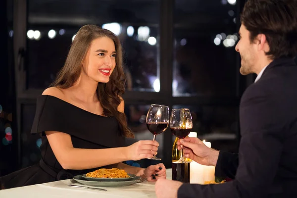 Happy couple in love clinking with wine Valentine date — Stok Foto