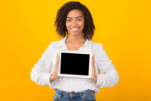 Χαμογελαστή μαύρη γυναίκα που δείχνει κενή οθόνη υπολογιστή — Φωτογραφία Αρχείου