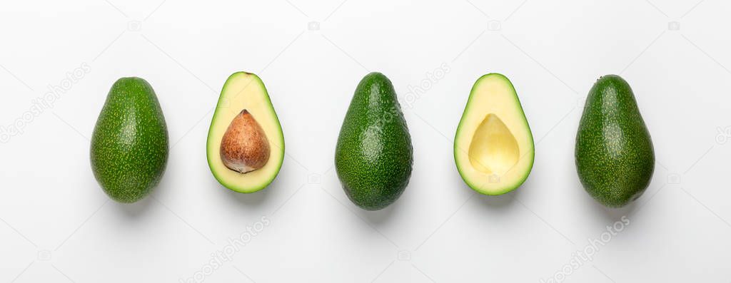 Composition of avocados and halves on white background