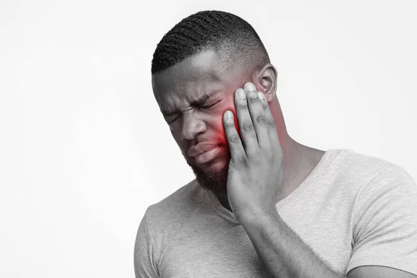 Jaded afro man touch his face, having tooth pain — Stock fotografie