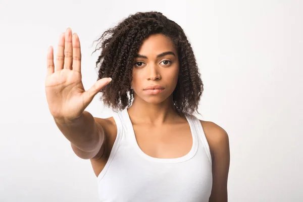 Nero ragazza mostrando stop segno su bianco sfondo — Foto Stock