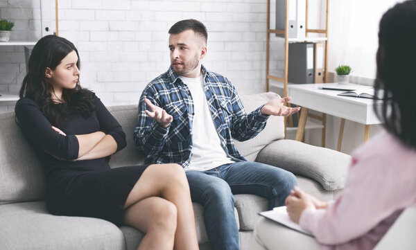 Angry spouses arguing at marital consultation, panorama