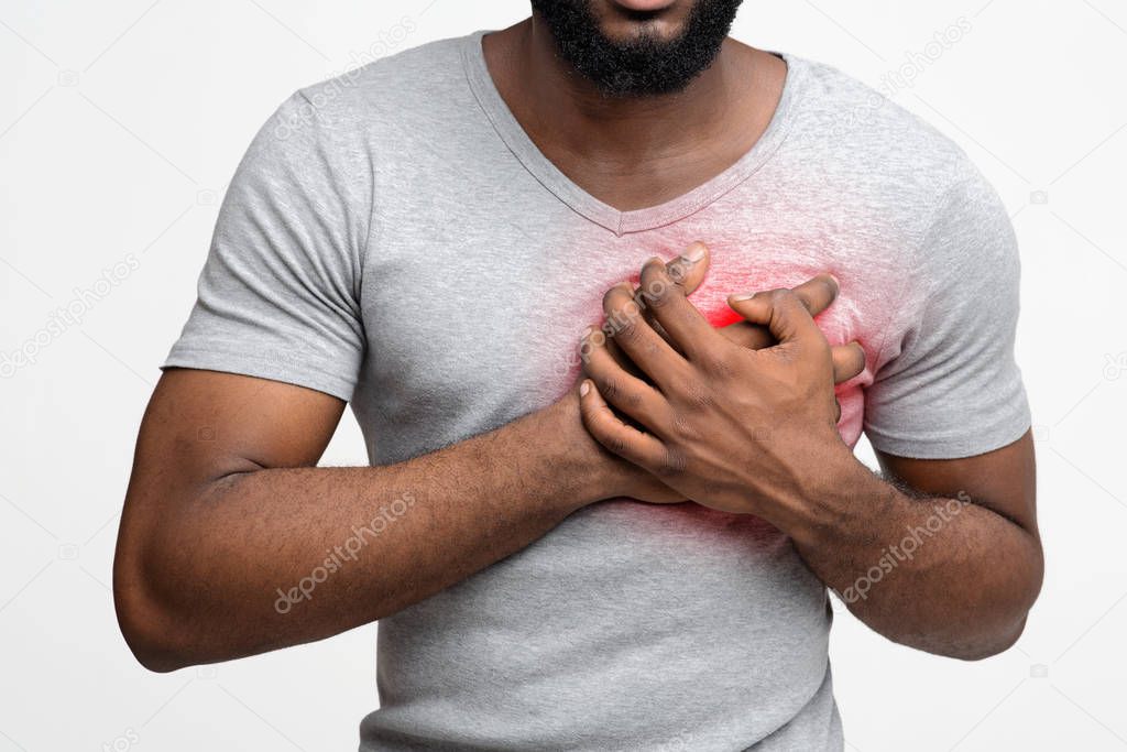 Cropped of young black man having heart attack