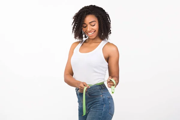 Portrait of african american woman measuring waist — Stock Photo, Image