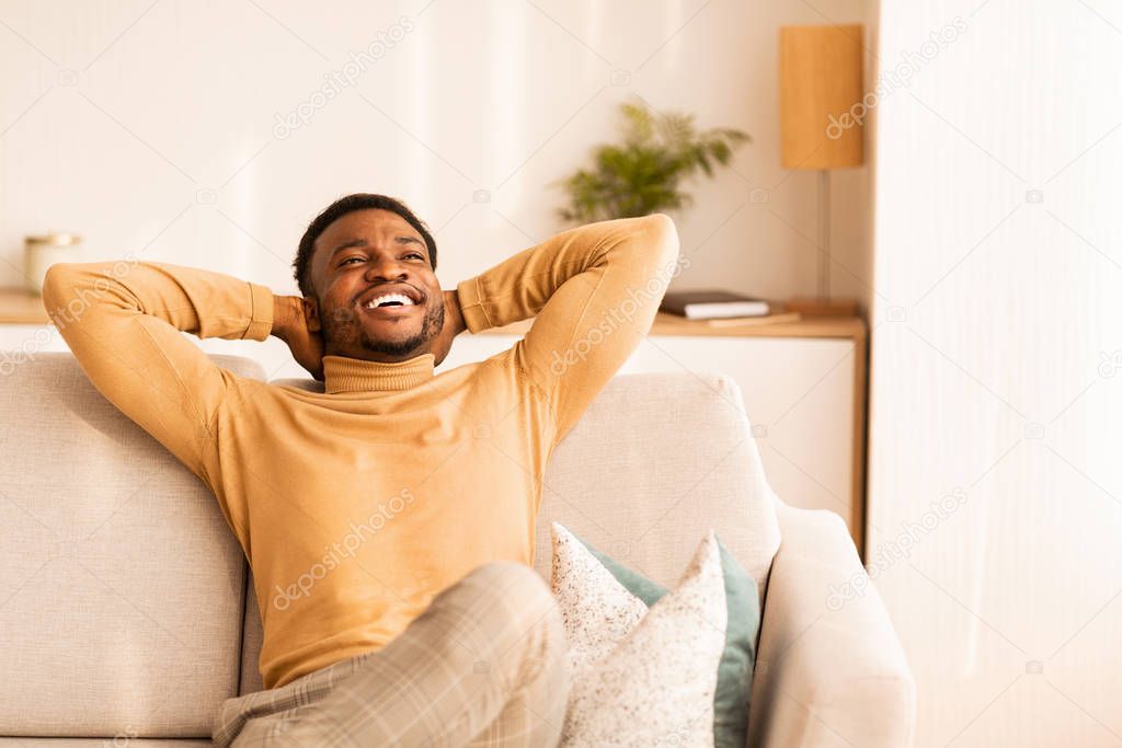 Happy Afro Man Relaxing Sitting On Sofa Indoor, Copy Space