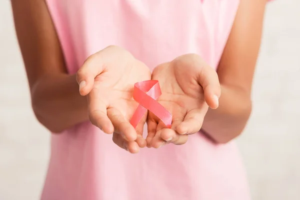 Unrecognizable Woman Holding Pink Ribbon Symbol Standing Over White Background — 스톡 사진