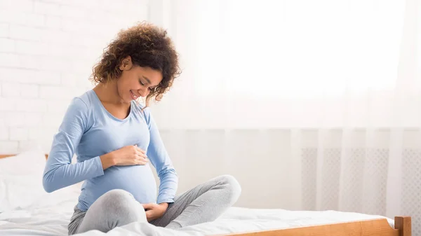 Linda mujer embarazada afro acariciando su vientre — Foto de Stock