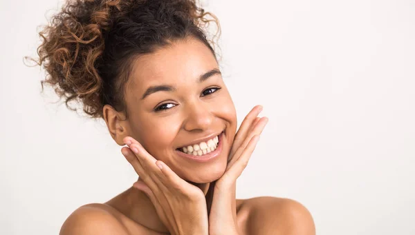 Happy afro woman touching her smooth cheeks — Stock Photo, Image