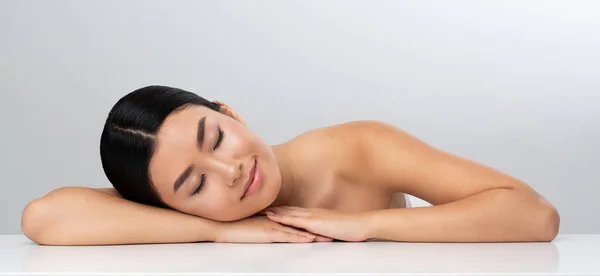 Spa and wellness. Girl relaxing after massage, grey background — Stock Photo, Image