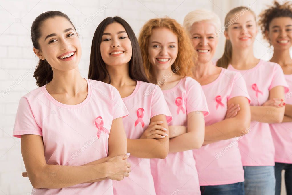 Ladies With Pink Ribbons On T-Shirts Posing On White Background