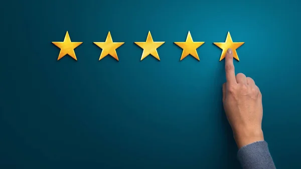 Hand of client giving a five star rating on blue background