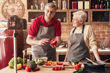Modern yaşlı çift yemek blogları için video kaydediyor.