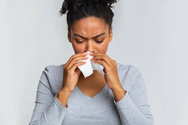 Woman touching her nose with napkin, having runny nose — Stock Photo, Image
