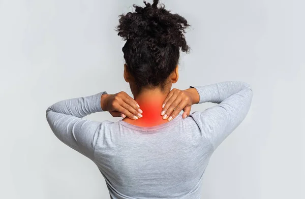 Black woman with neck pain, back view — Stock Image Black woman with neck pain, back view Royalty Free Stock Photos