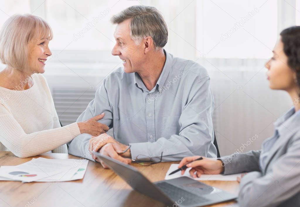 Mature couple talking to financial advisor at home