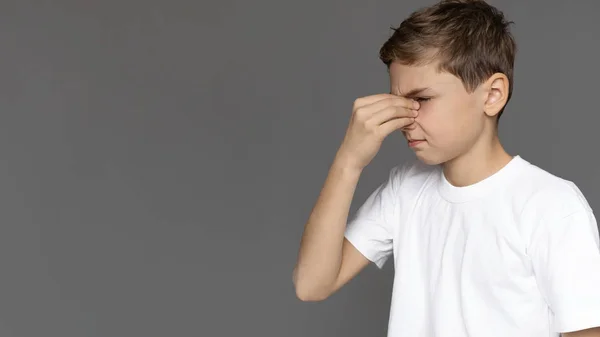 Teenage boy rubbing nose, feeling tired, panorama — Stock Photo, Image