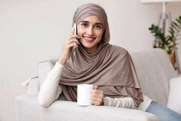 Happy Arabic Girl Calling To Friend And Drinking Coffee At Home — Stok Foto