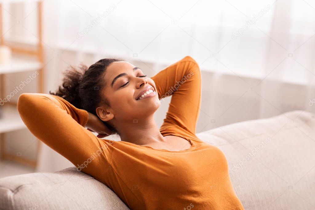 Happy Afro Girl Relaxing Sitting On Couch At Home