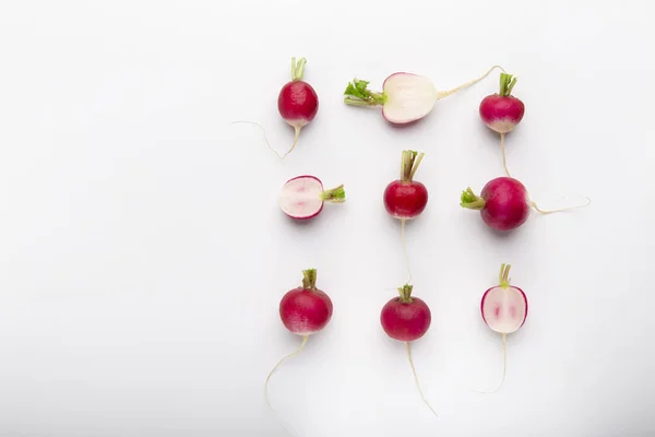 Composition of cut and whole radishes on white background — Stock Photo, Image