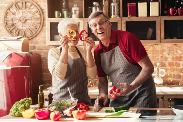 Üst düzey çift mutfakta taze sebzelerle oynuyor.