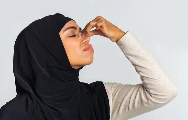 Tired afro muslim woman in hijab touching her nose bridge — Stock Photo, Image