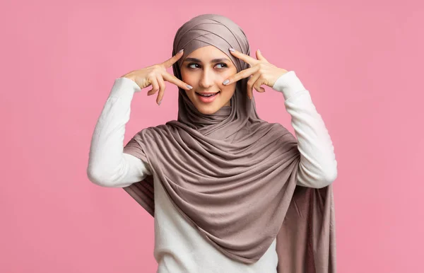 Mysteriöses muslimisches Mädchen im Hijab, das ihre Augen mit Fingern umrahmt — Stockfoto