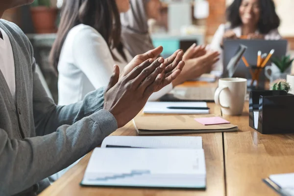 Close up of international team of employees clapping hands — Stock Photo, Image