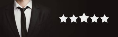Unrecognizable businessman standing over dark background with five stars icons clipart