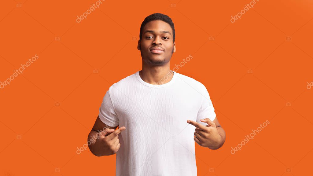 You Found Right Guy, Pick Me. Self-assured black man promoting himself, pointing at body over orange background