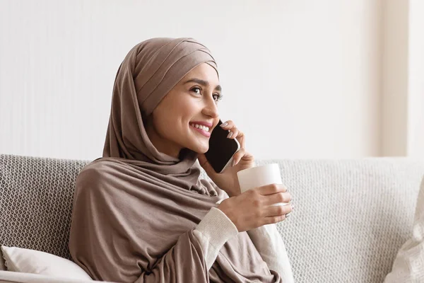 Girl In Hijab Talking On Phone And Drinking Tea At Home — Stok Foto