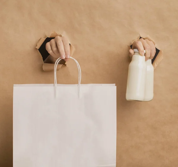Hands suggesting detox coconut milk and paper bag — Stock Photo, Image