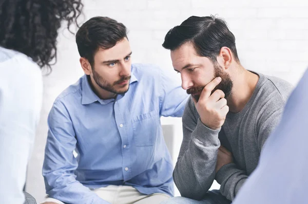Understanding people giving support to depressed man at group therapy session — Stock Photo, Image
