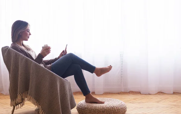 Donna godendo di cacao marshmallow e la navigazione sul telefono — Foto Stock