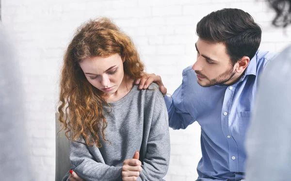 Caring husband comforting his depressed wife on meeting with marriage counsellor — Stock Photo, Image