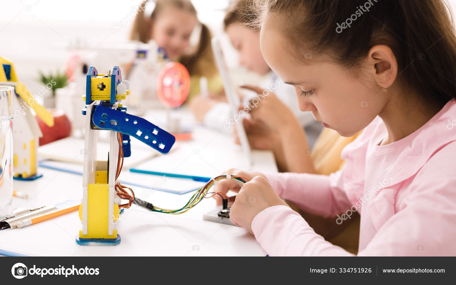 Smart girl programming robot, working with wires circuits Stock by ©Milkos 334751926