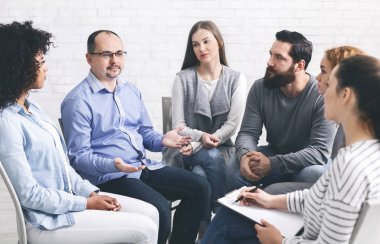 Man sharing his story, telling about problems at group therapy session