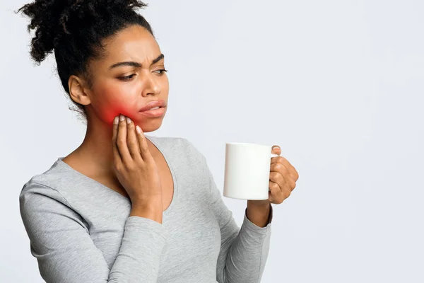 Negro chica bebiendo café y tocando su mejilla — Foto de Stock