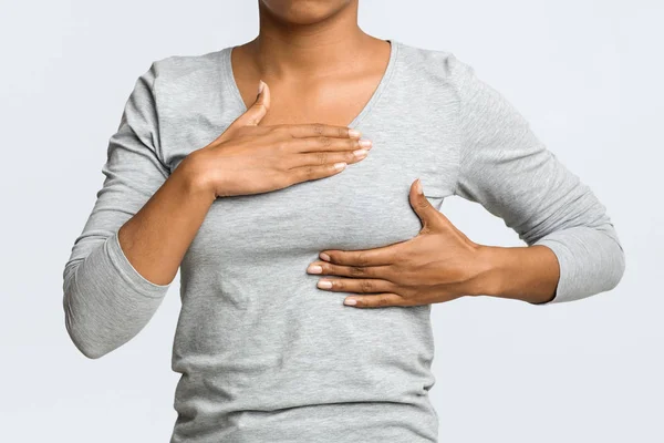 Cropped of black woman massaging her chest — Stock Photo, Image
