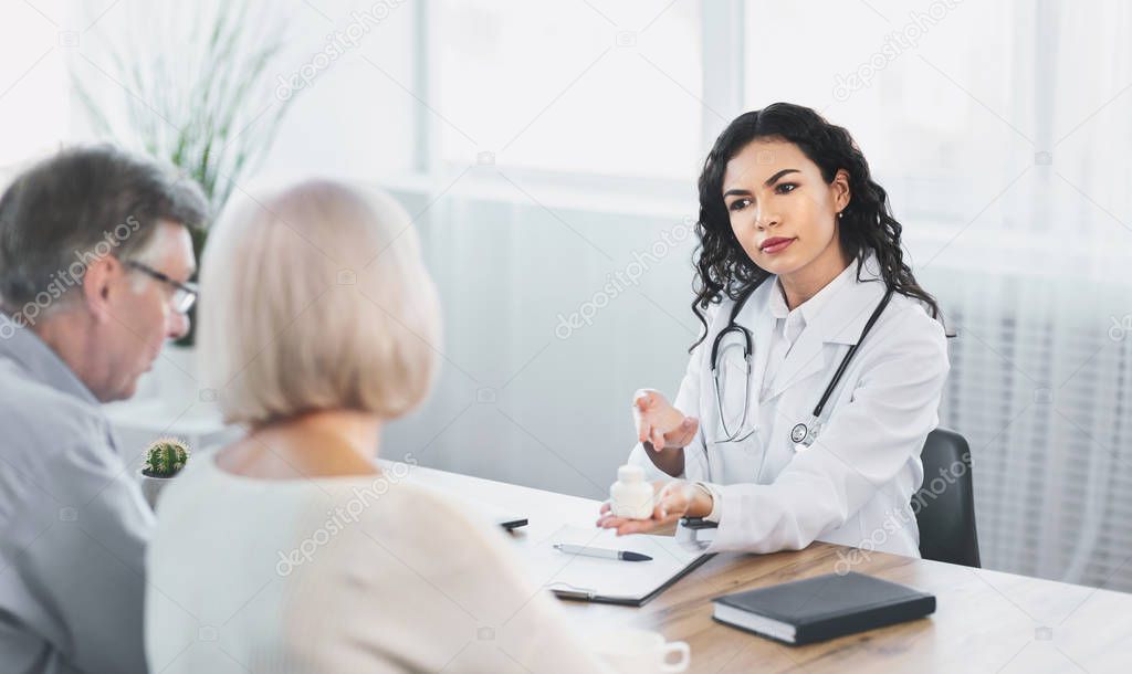 Angry mexican nurse giving treatment to mature patients