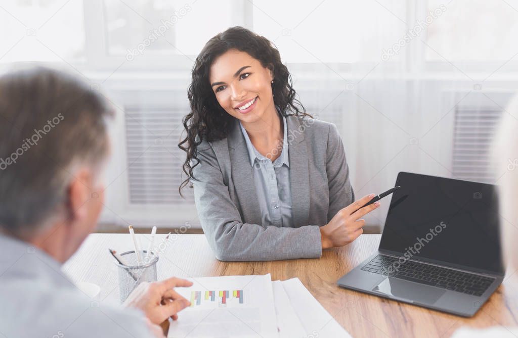 Mature couple consulting with financial advisor at home