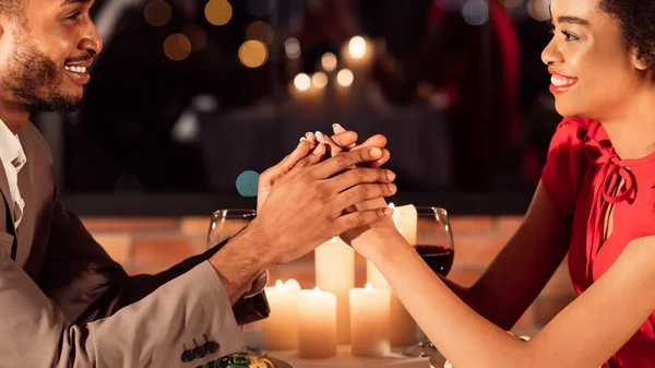 Casal em data romântica segurando as mãos sorrindo sentado no restaurante — Fotografia de Stock