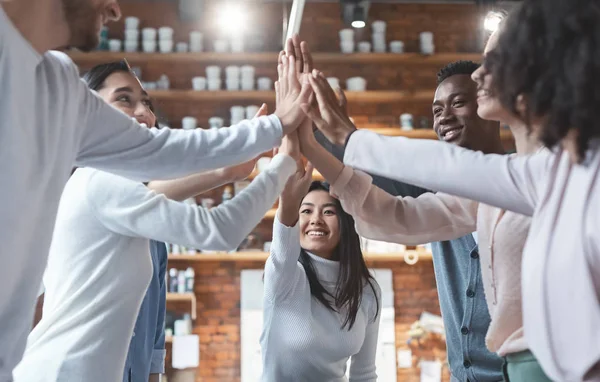Young international business team giving high five in office — Stock Photo, Image
