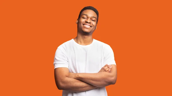 Smiling afro guy portrait on orange background — Stock Photo, Image