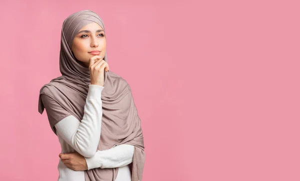 Portrait of thoughtful millennial islamic woman in headscarf over pink background — Stok Foto