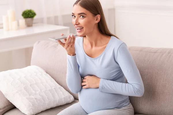 Pregnant Lady Using Mobile Phone Voice Assistant Sitting On Sofa — Stock Photo, Image