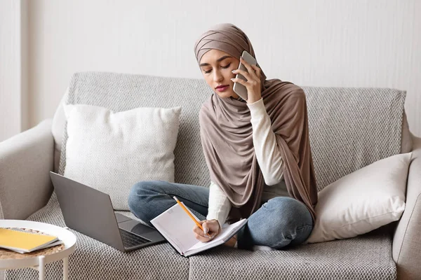 Wanita Muslim Sibuk Berbicara di Cellphone Dan Mengambil Catatan Di Rumah — Stok Foto