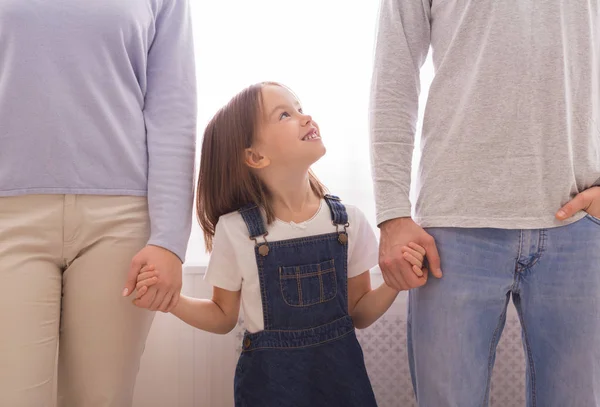 快乐的小女孩与父母牵着手，看着父亲 — 图库照片