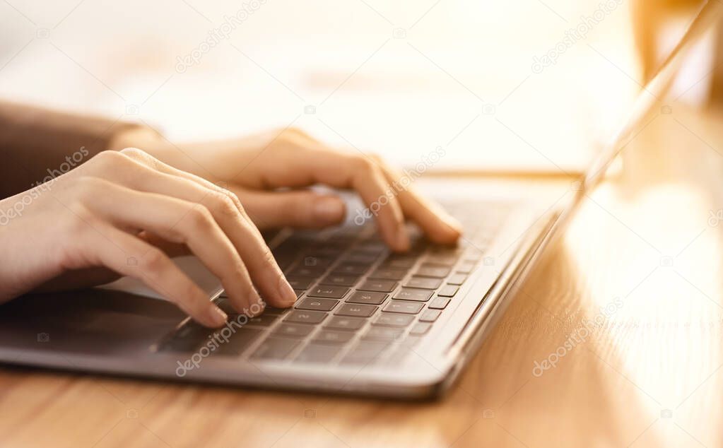 Cropped image of manager typing on laptop computer