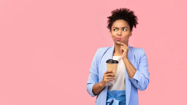 Pensive afro woman holding coffee mug at studio — 스톡 사진