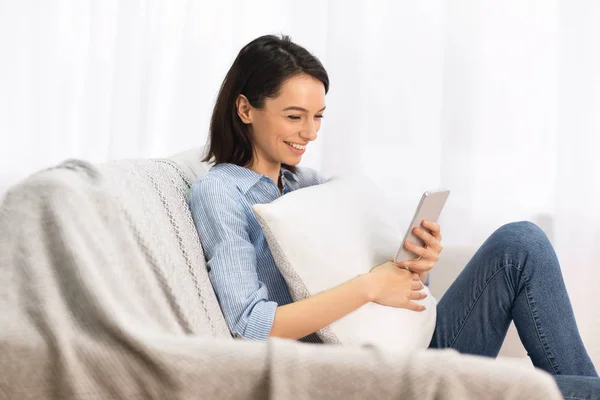 Girl having rest at home using phone — 스톡 사진